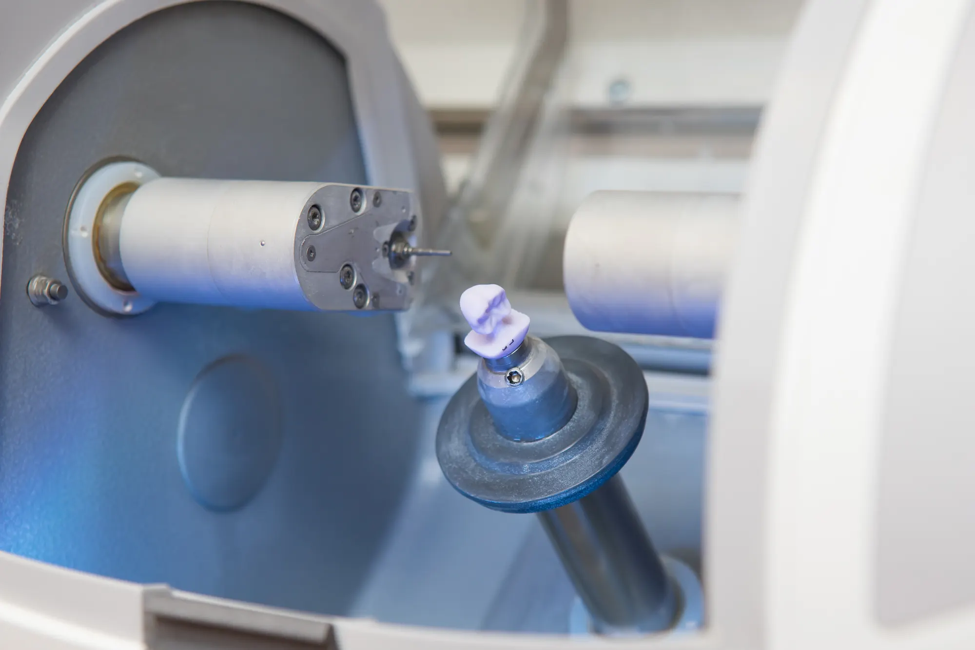 A finished tooth restoration held in a dental milling machine